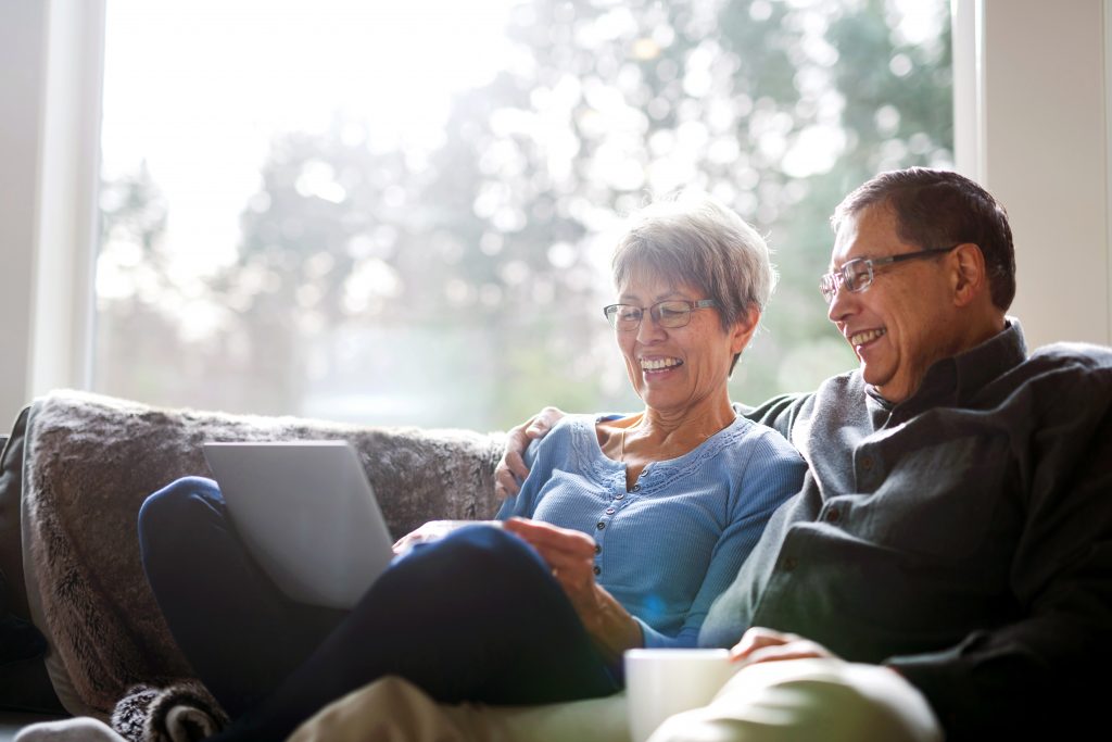 older couple relaxing on the couch, cost push inflation, purchasing power, money supply