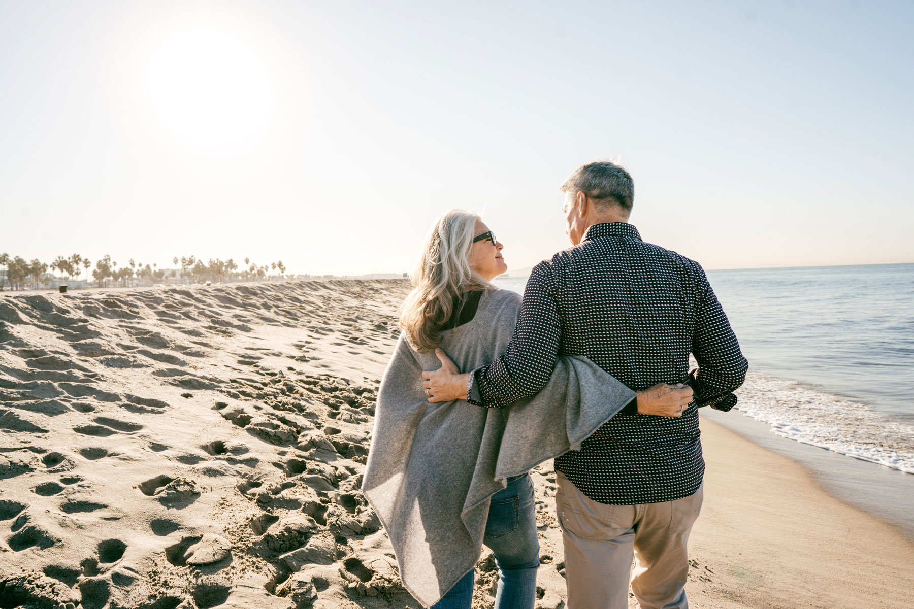 retired couple walking on beach, asset allocation, financial planning