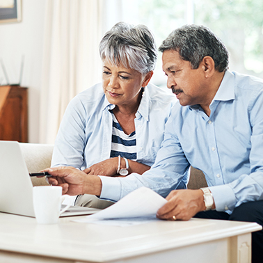 retiree couple reading computer, retirement planning, retirement tips
