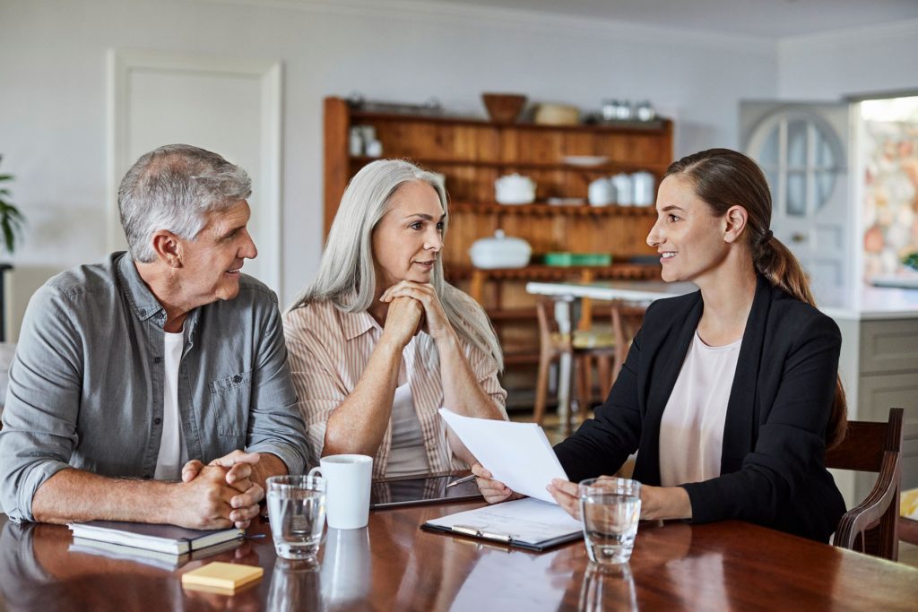 retired couple meeting with their financial advisor, annual contribution limit, required minimum distributions