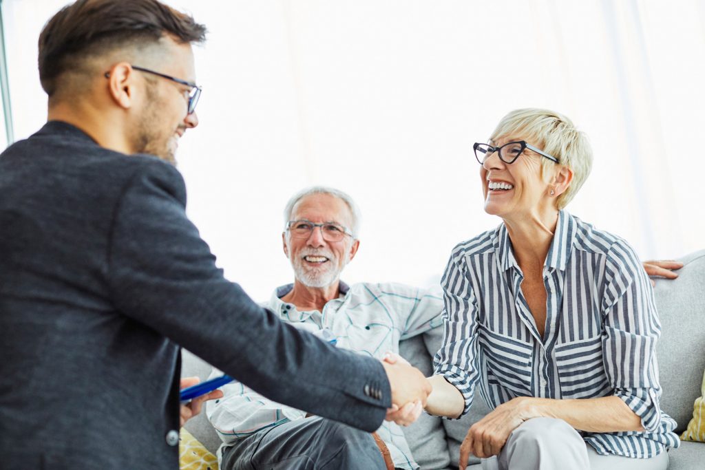 retirement couple meeting with financial advisor, traditional ira, roth iras